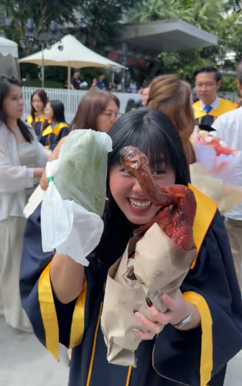SG girl laughing over her graduation gifts
